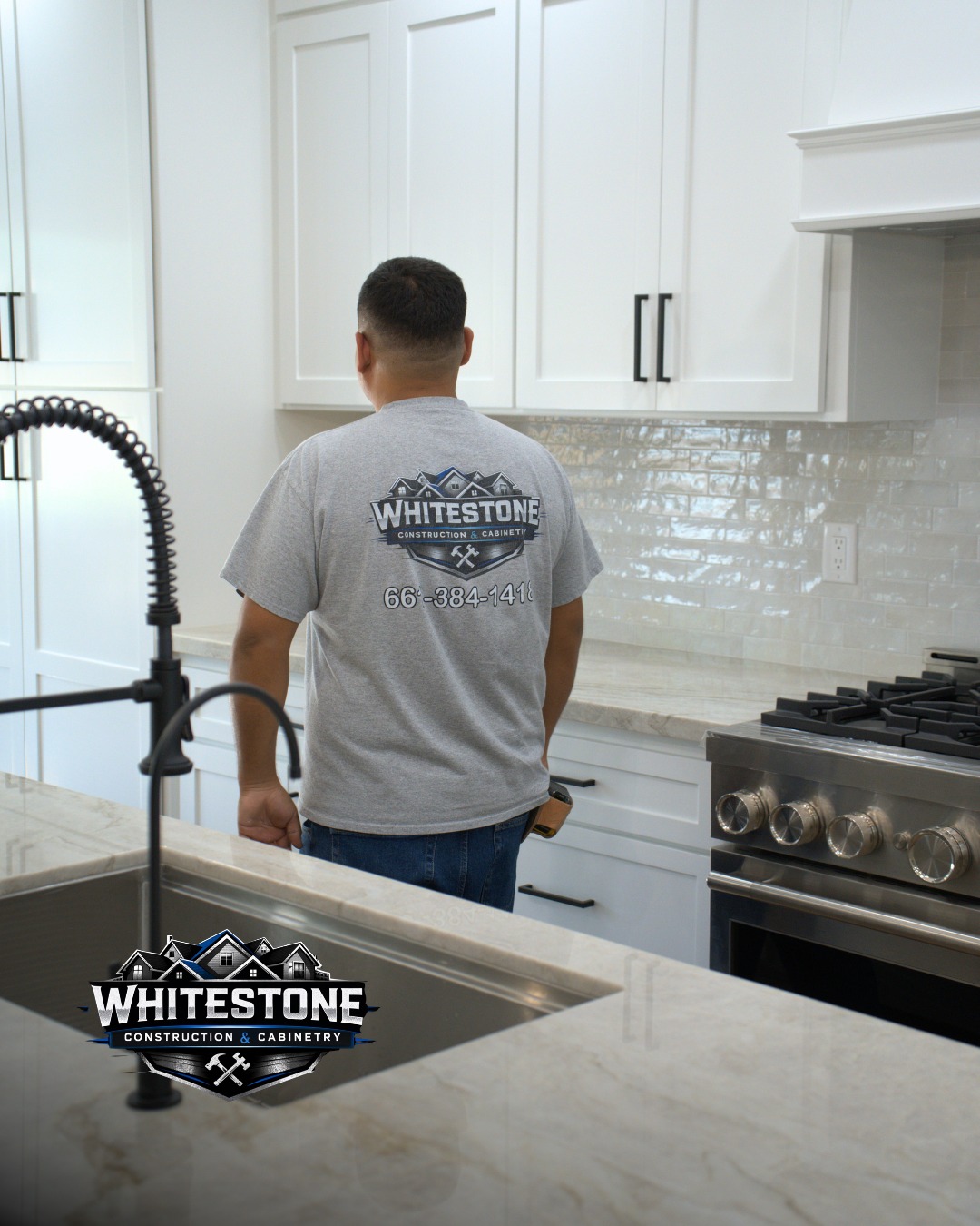 Contractor in a Whitestone Construction shirt standing in a finished white kitchen, with the Whitestone Construction & Cabinetry logo in the lower corner.